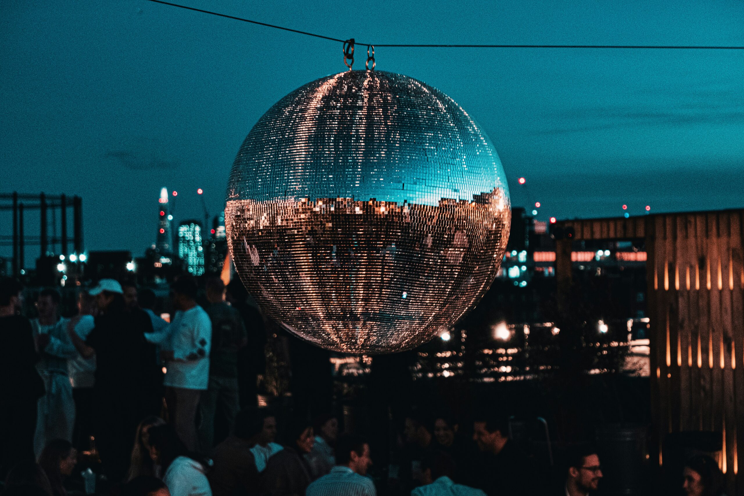 A mirror prison ball hangs over the London skyline at dusk. Photo by Samuel Regan Asante.